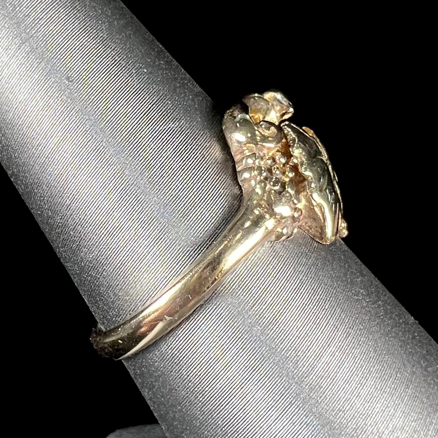 A ladies' two tone rose and yellow gold Black Hills gold diamond ring.  The ring exhibits a leaf design.