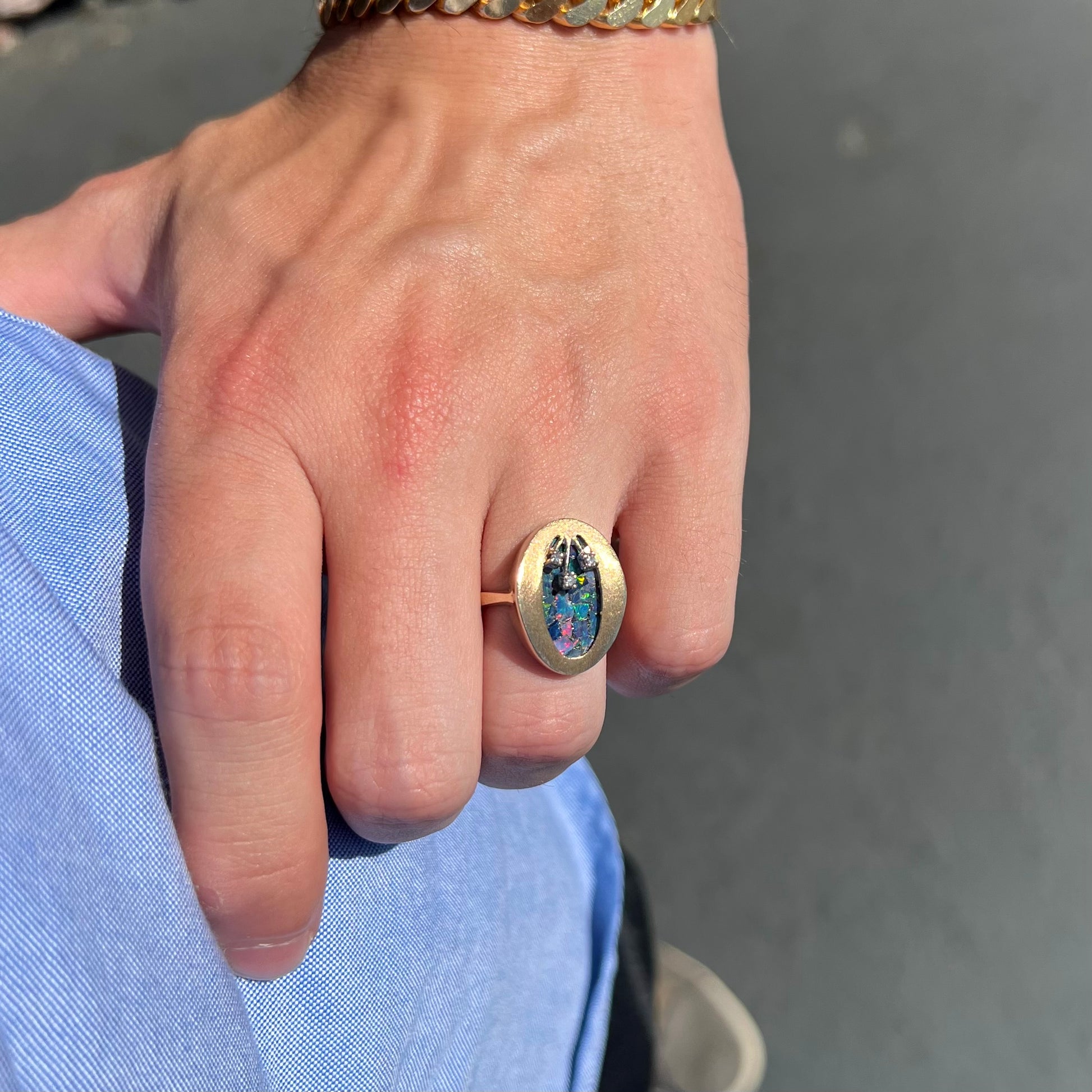A vintage mosaic opal ring set with diamond accents in 10 karat yellow and white gold.