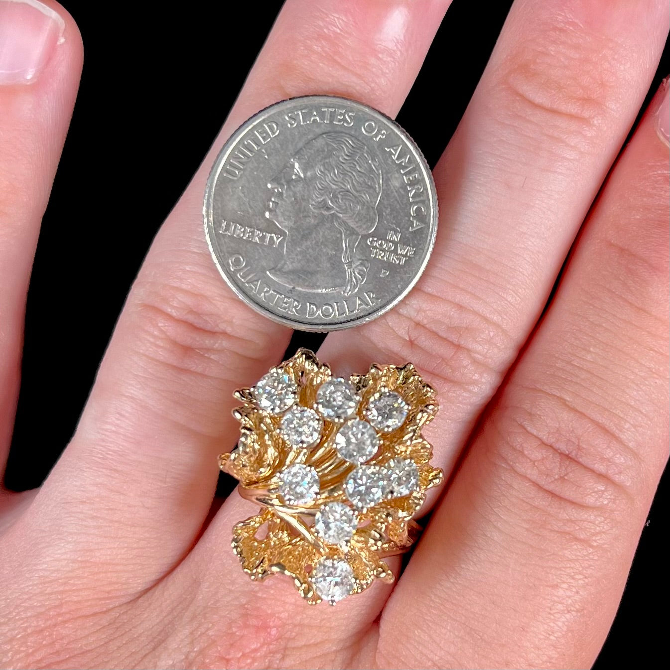 A ladies' 1950's style yellow gold and diamond cluster ring. The ring is shaped like a leaf with 10 round diamonds set in it.