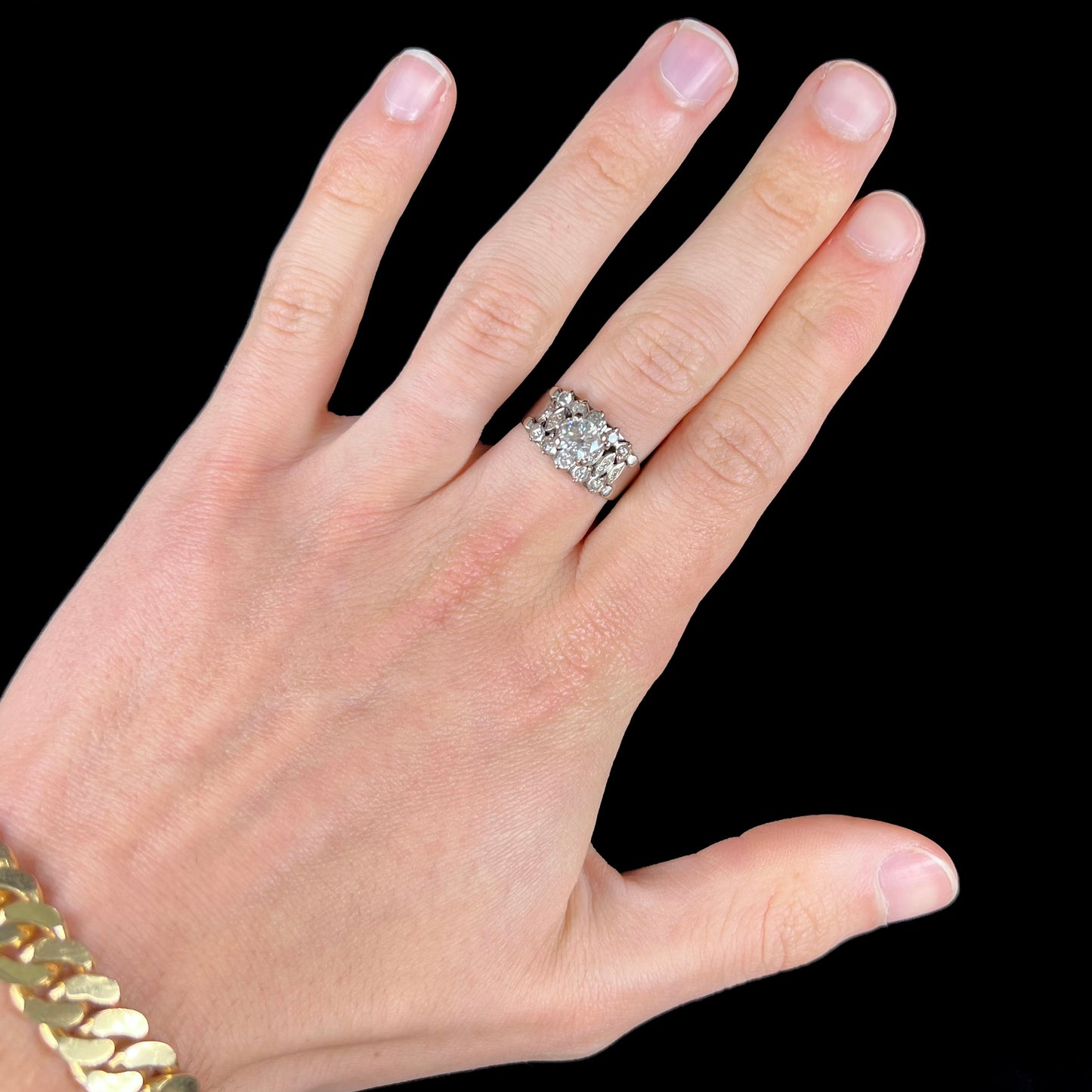 A vintage, 1940's style white gold diamond wedding ring set with a 0.68ct round diamond. The diamond has a noticeable black crystal inclusion.