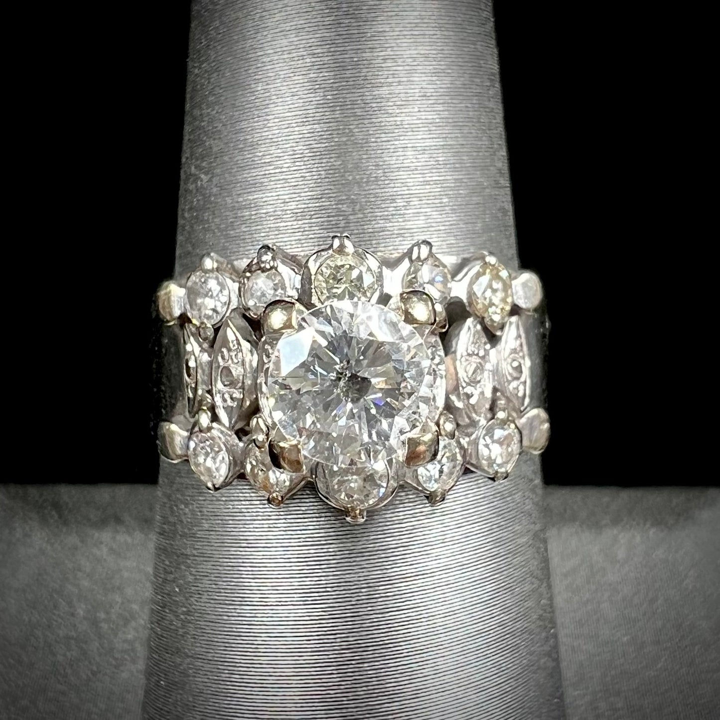 A vintage, 1940's style white gold diamond wedding ring set with a 0.68ct round diamond. The diamond has a noticeable black crystal inclusion.