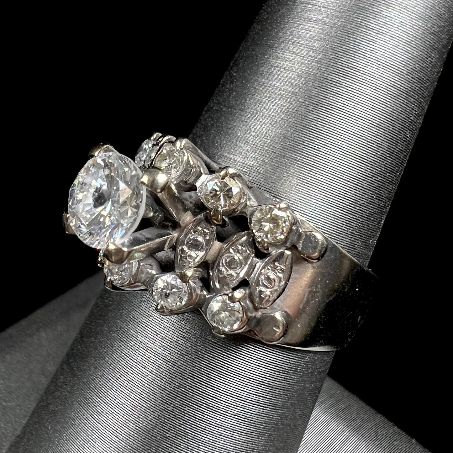 A vintage, 1940's style white gold diamond wedding ring set with a 0.68ct round diamond. The diamond has a noticeable black crystal inclusion.