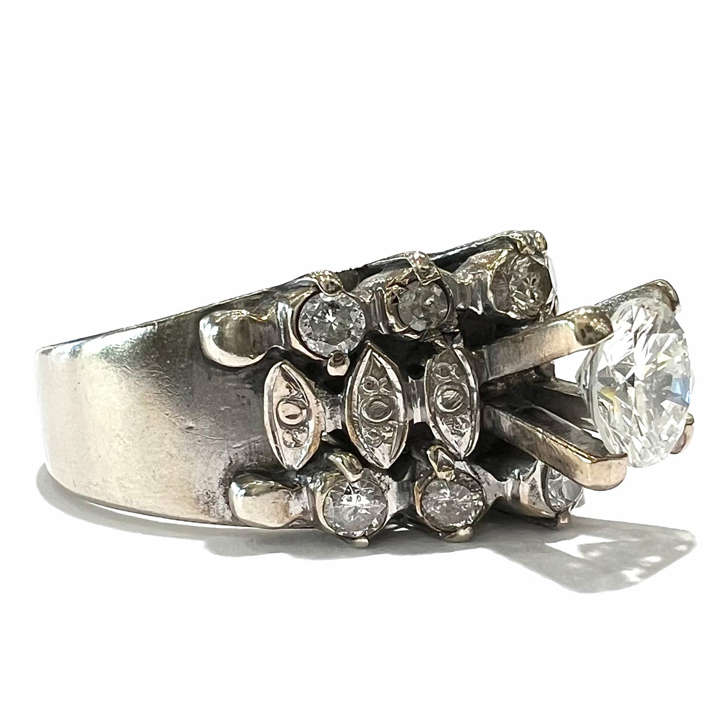 A vintage, 1940's style white gold diamond wedding ring set with a 0.68ct round diamond. The diamond has a noticeable black crystal inclusion.