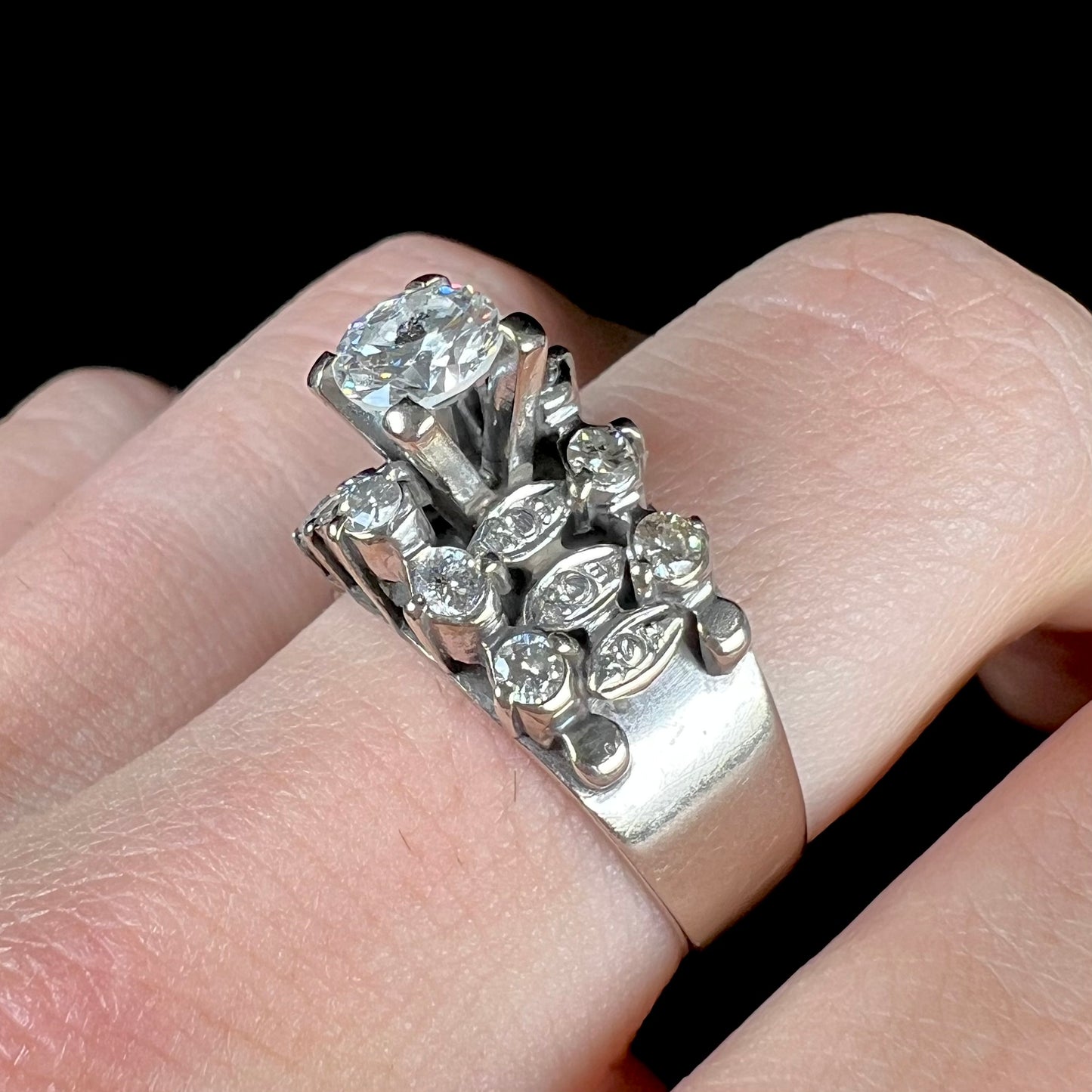 A vintage, 1940's style white gold diamond wedding ring set with a 0.68ct round diamond. The diamond has a noticeable black crystal inclusion.