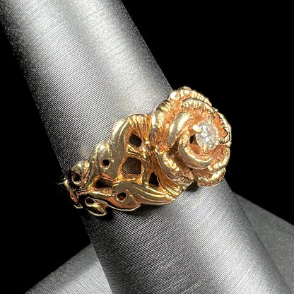 A ladies' yellow gold rose style ring set with a natural 0.10ct diamond.