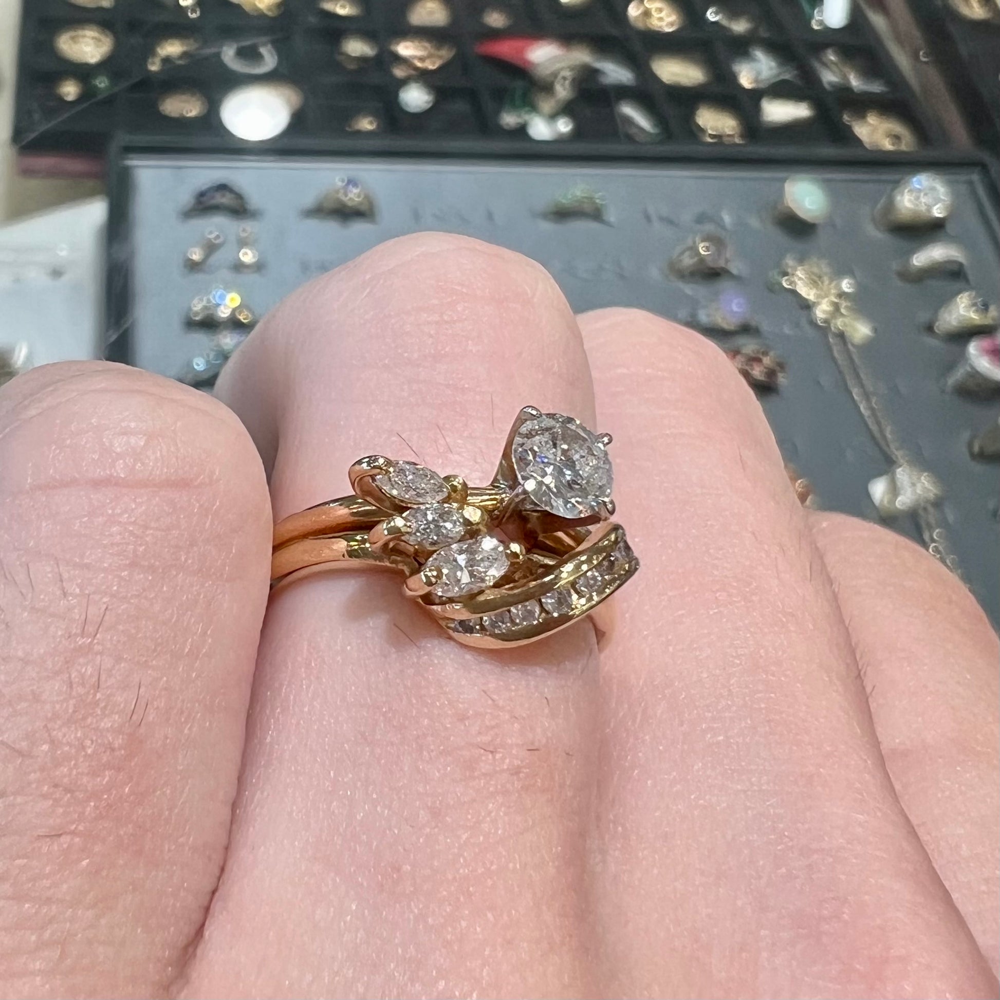 A vintage diamond wedding set with a round brilliant cut center stone and marquise cut accents in yellow gold.