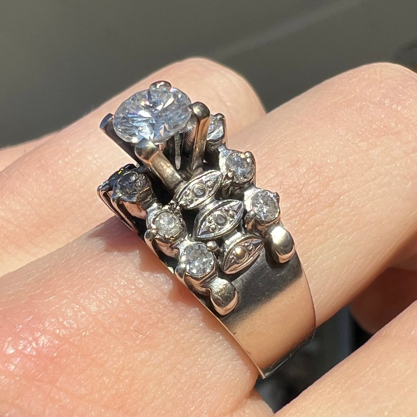 A vintage, 1940's style white gold diamond wedding ring set with a 0.68ct round diamond. The diamond has a noticeable black crystal inclusion.