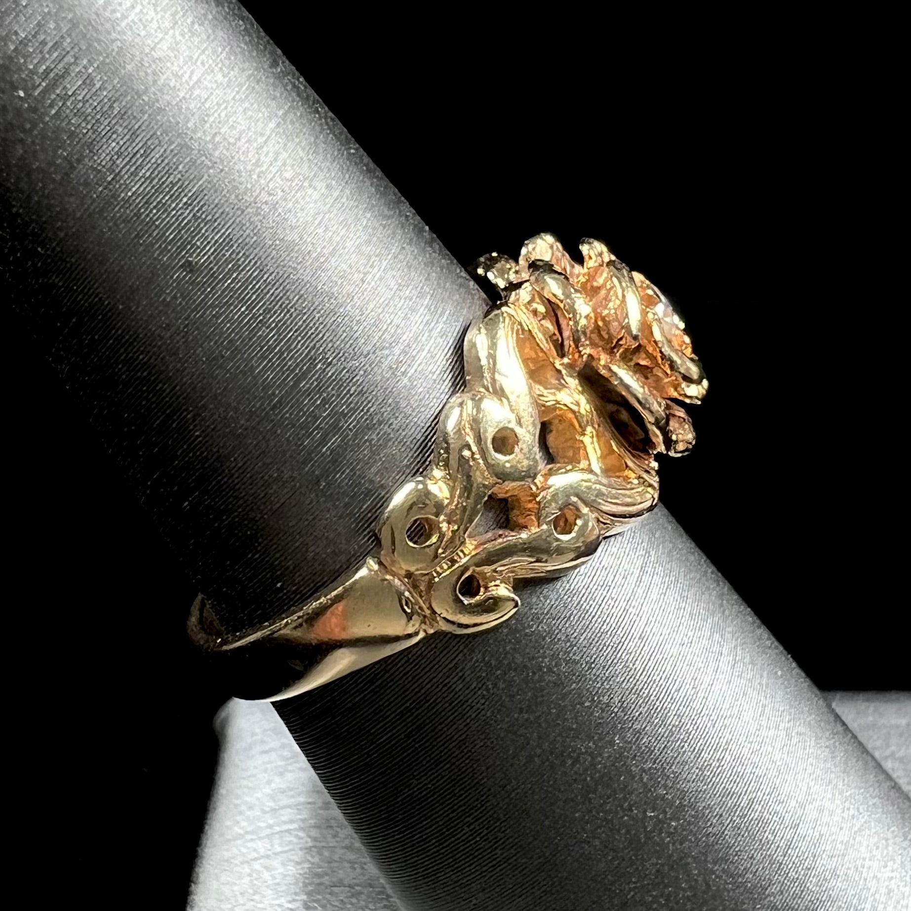 A ladies' yellow gold rose style ring set with a natural 0.10ct diamond.