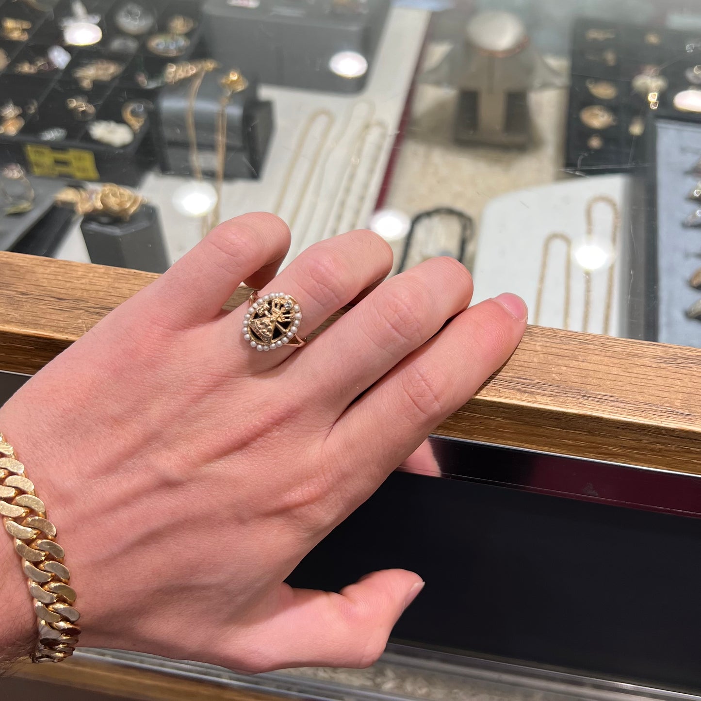 A ladies' Job's Daughters youth organization ring cast in 14 karat gold, set with a diamond and string of pearls.