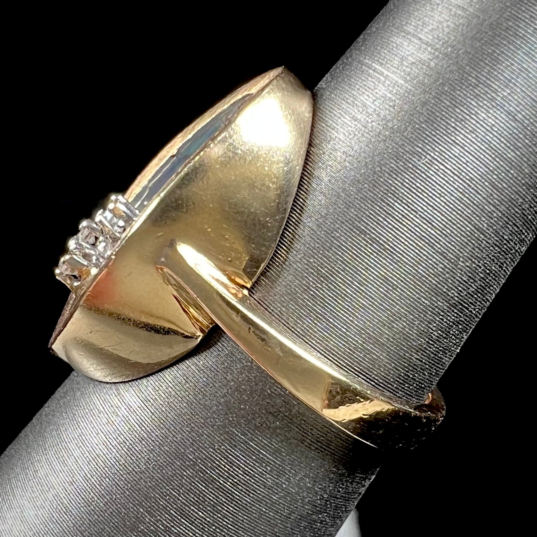 A vintage mosaic opal ring set with diamond accents in 10 karat yellow and white gold.
