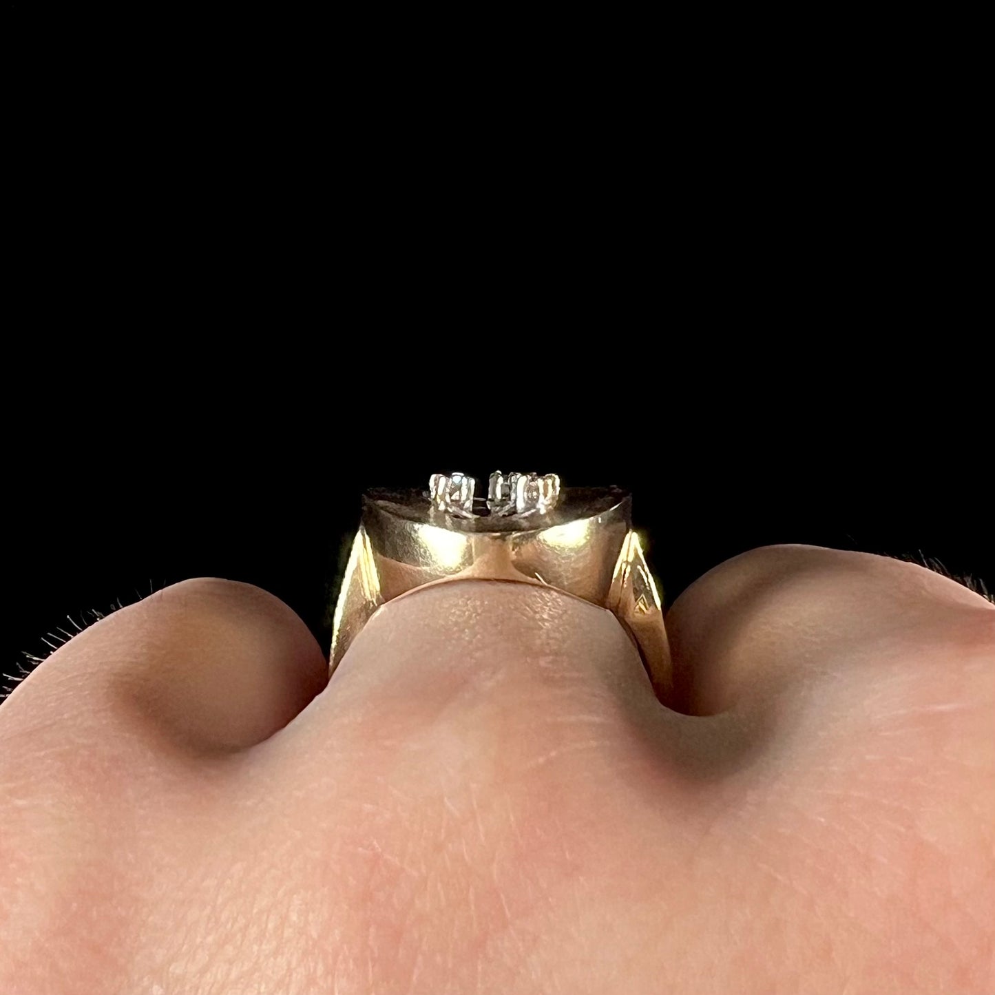 A vintage mosaic opal ring set with diamond accents in 10 karat yellow and white gold.
