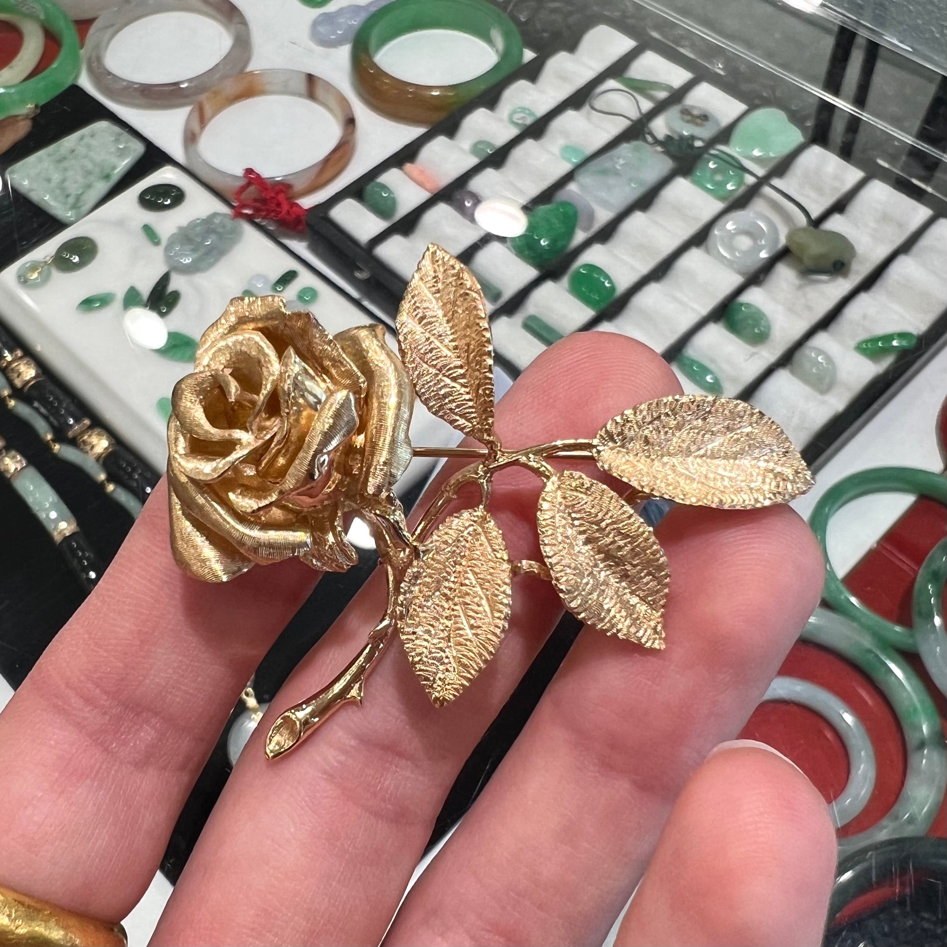 A vintage 14 karat yellow gold rose brooch.