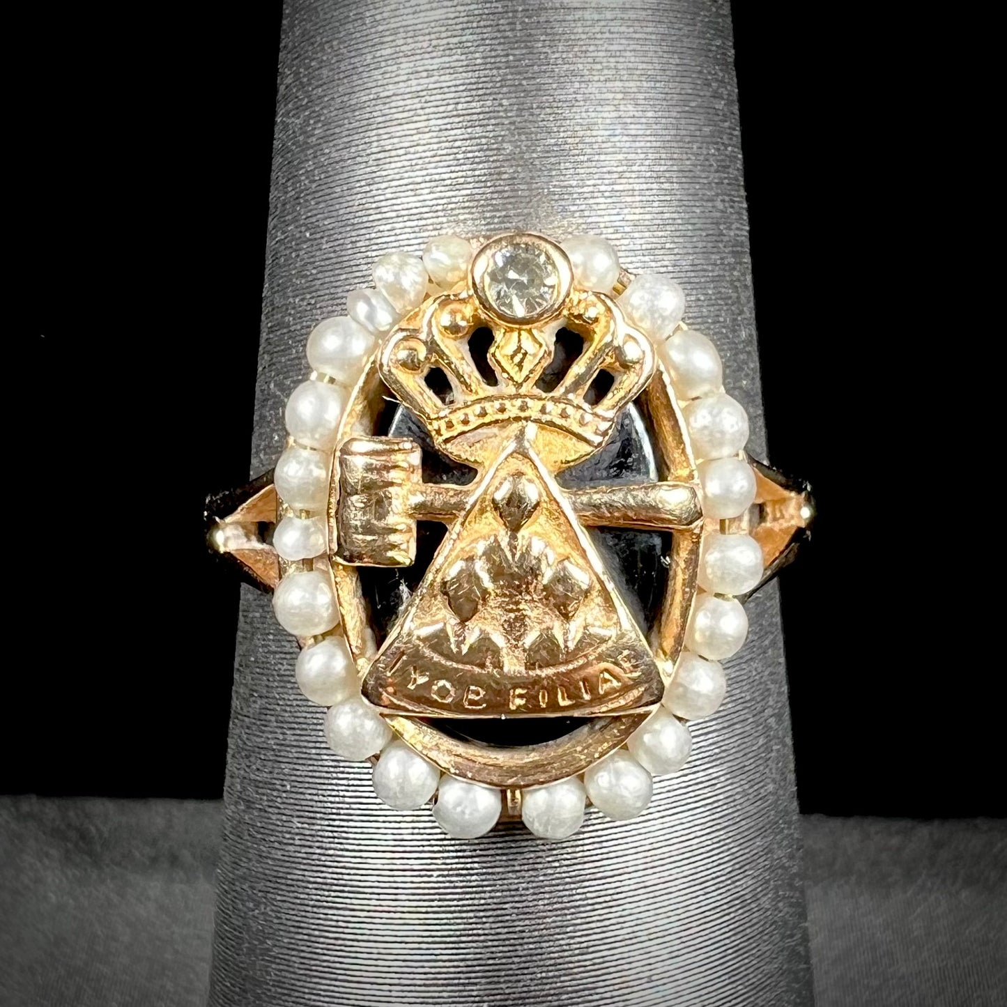 A ladies' Job's Daughters youth organization ring cast in 14 karat gold, set with a diamond and string of pearls.