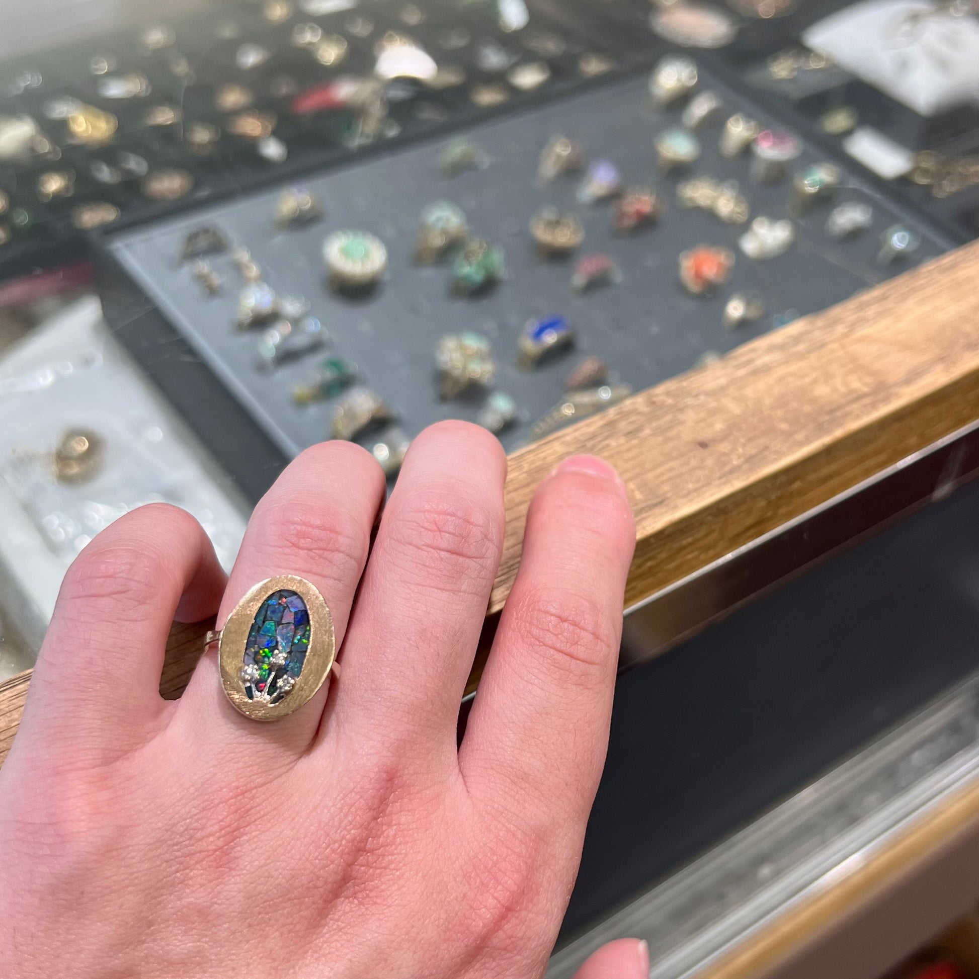 A vintage mosaic opal ring set with diamond accents in 10 karat yellow and white gold.