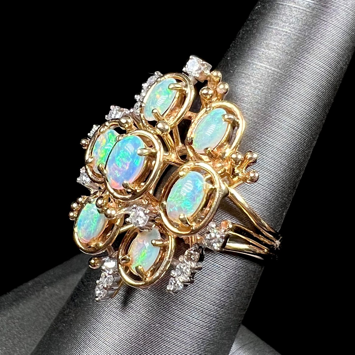 A ladies' vintage mid-century modern style opal and diamond cluster ring in yellow gold.