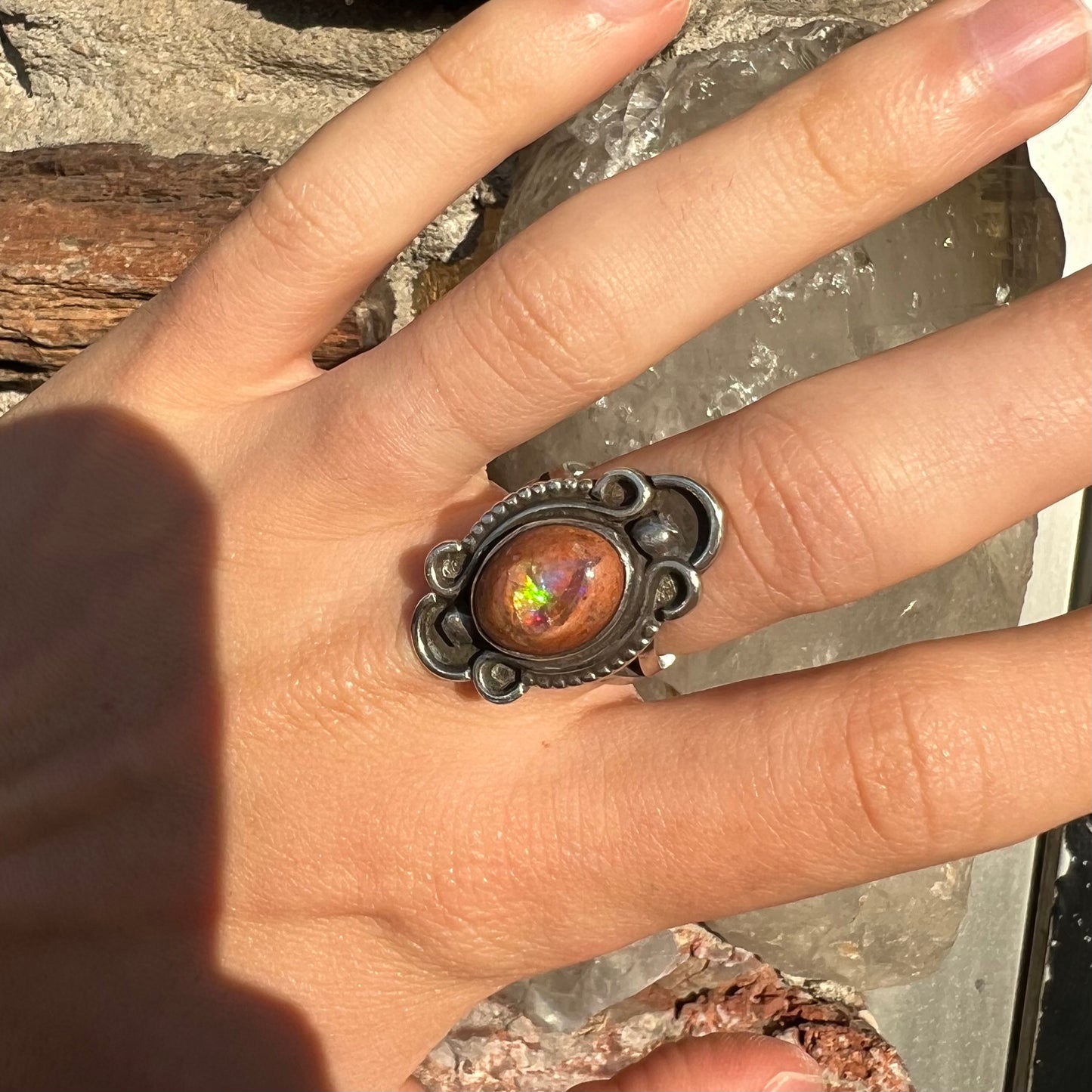 A vintage, Navajo style sterling silver ring set with an oval cabochon cut cantera fire opal stone.