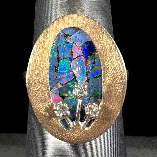 A vintage mosaic opal ring set with diamond accents in 10 karat yellow and white gold.