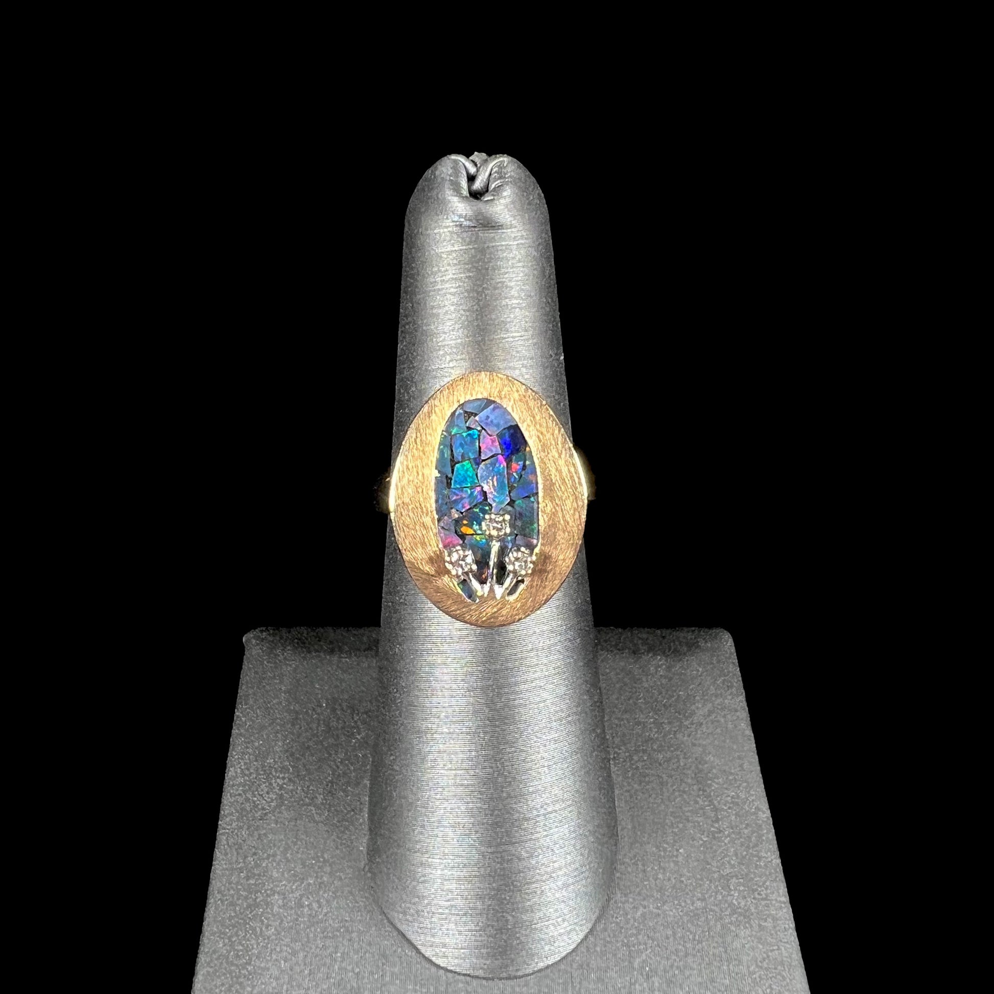 A vintage mosaic opal ring set with diamond accents in 10 karat yellow and white gold.