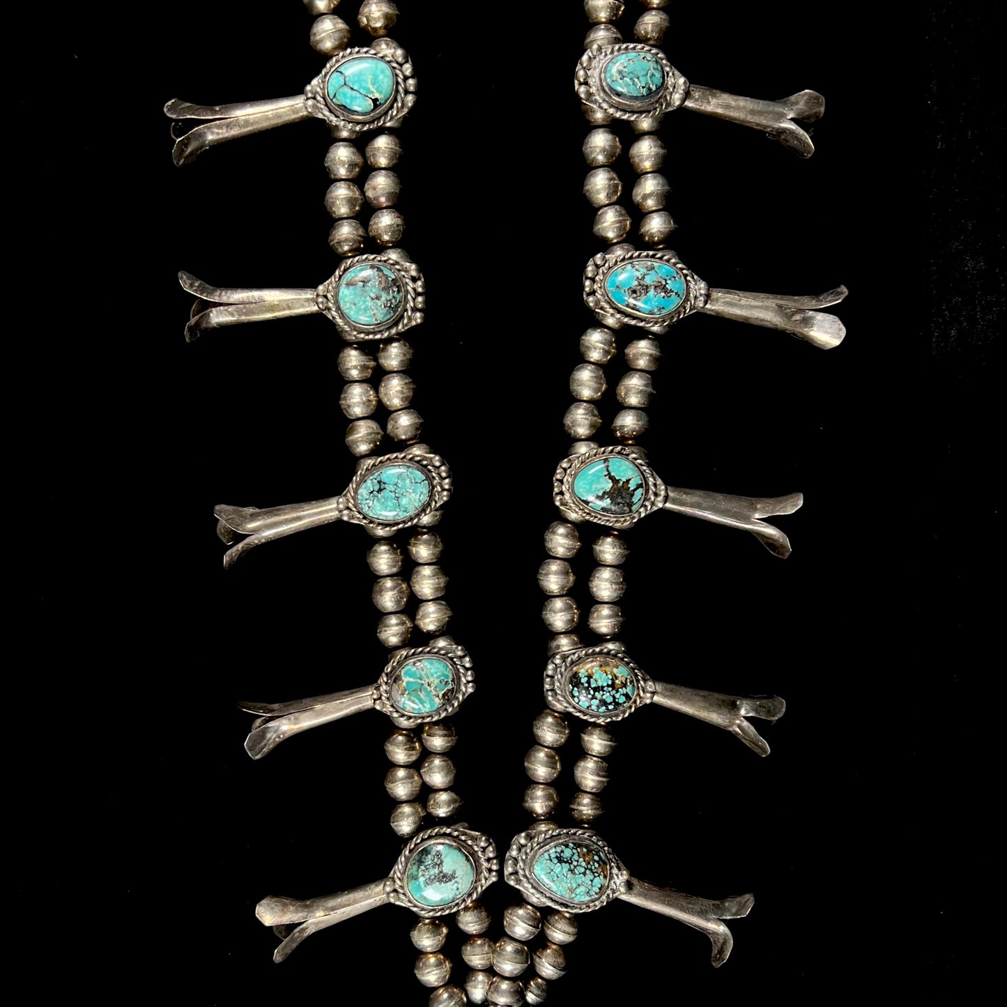 A Native American squash blossom necklace set with Number 8 MIne turquoise stones.