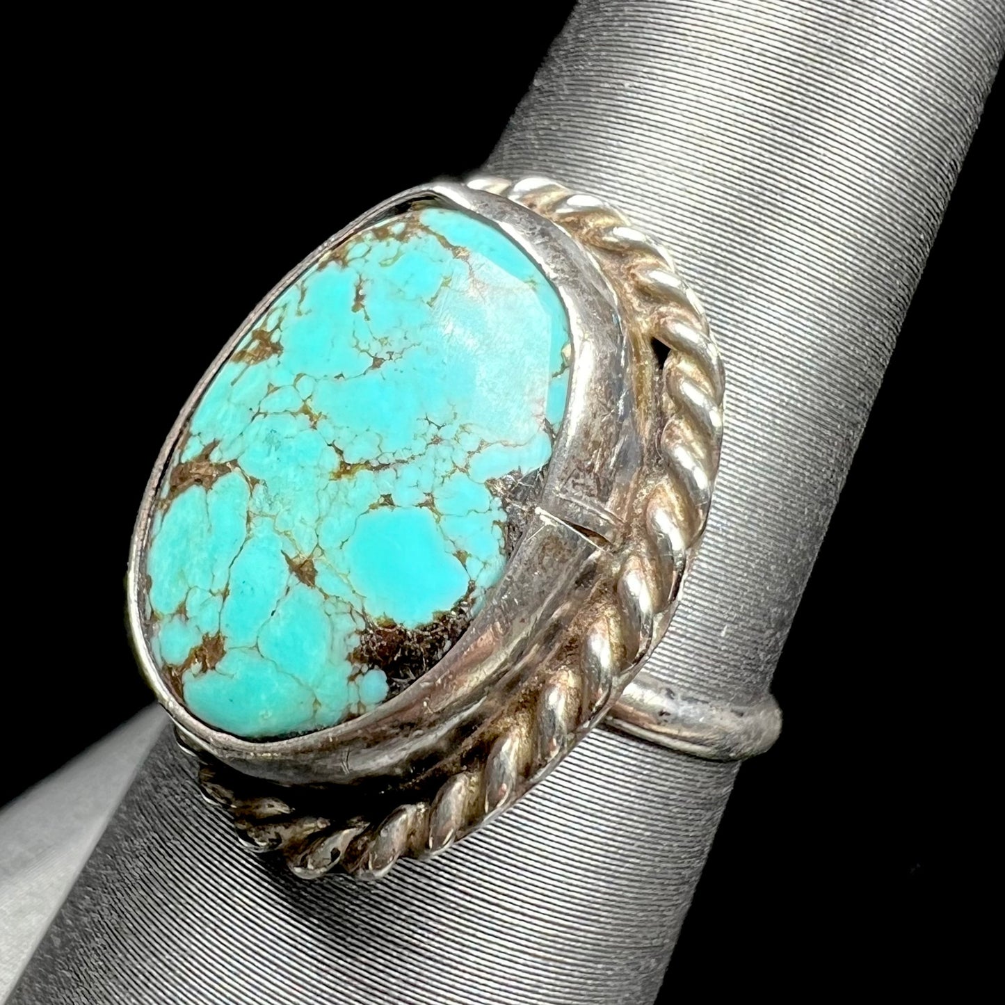 A handmade ladies' turquoise solitaire ring. The ring has a rope bezel design.