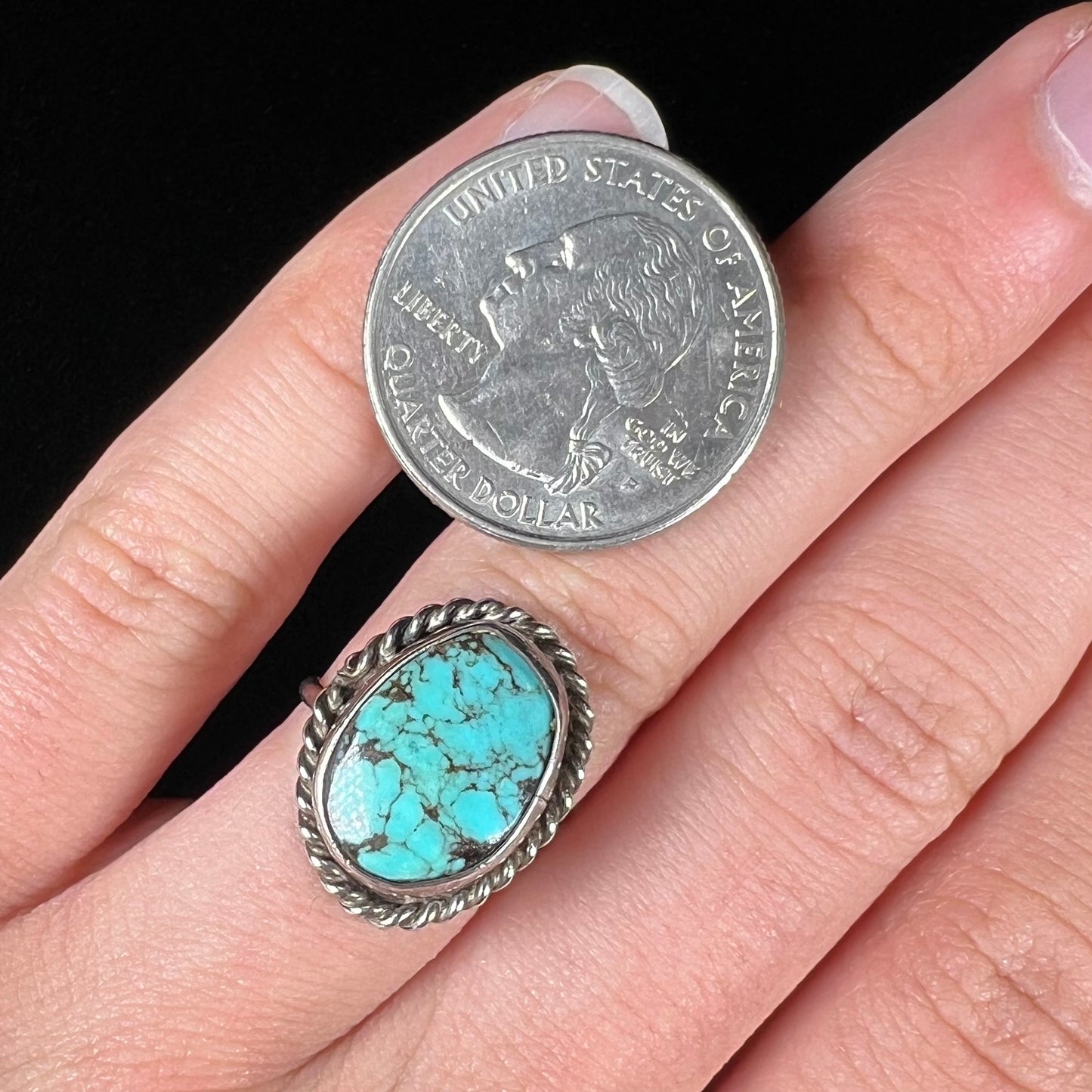 A handmade ladies' turquoise solitaire ring. The ring has a rope bezel design.