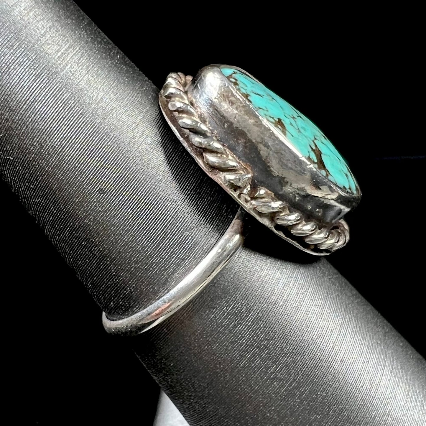 A handmade ladies' turquoise solitaire ring. The ring has a rope bezel design.
