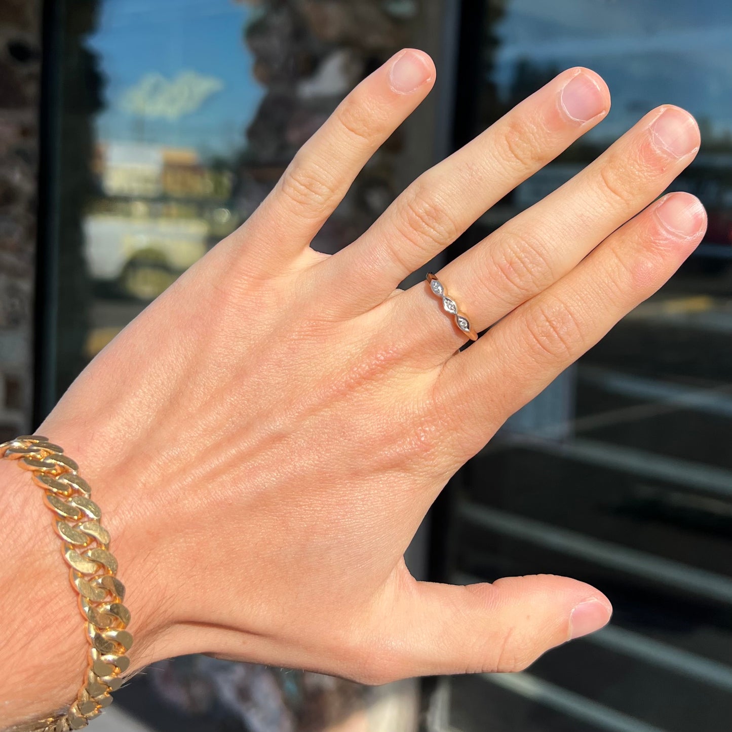 A vintage, yellow gold ladies' wedding band set with three single cut diamonds in marquise shaped designs.