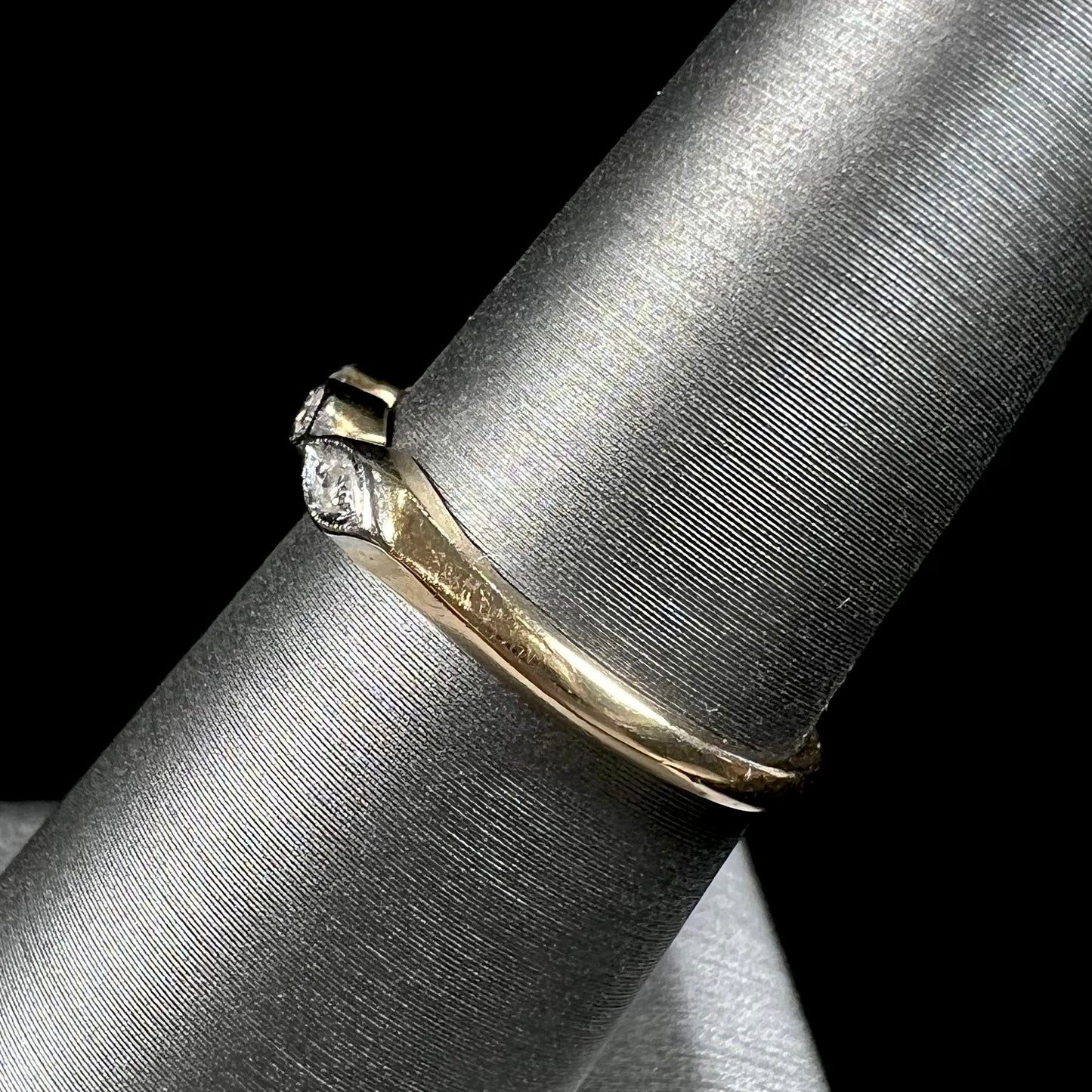 A vintage, yellow gold ladies' wedding band set with three single cut diamonds in marquise shaped designs.