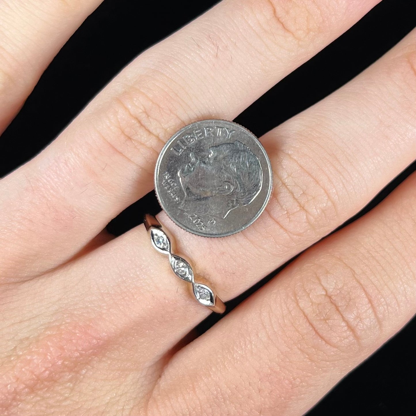 A vintage, yellow gold ladies' wedding band set with three single cut diamonds in marquise shaped designs.