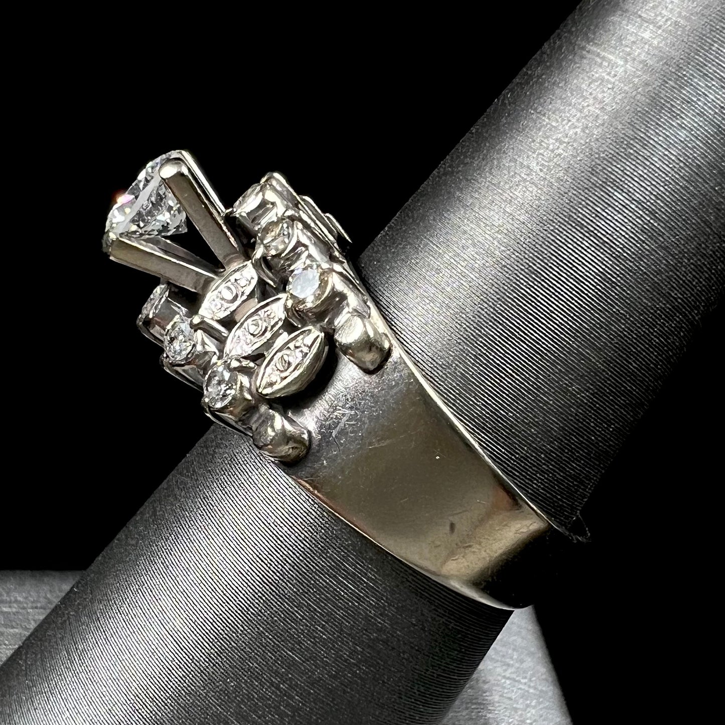 A vintage, 1940's style white gold diamond wedding ring set with a 0.68ct round diamond. The diamond has a noticeable black crystal inclusion.