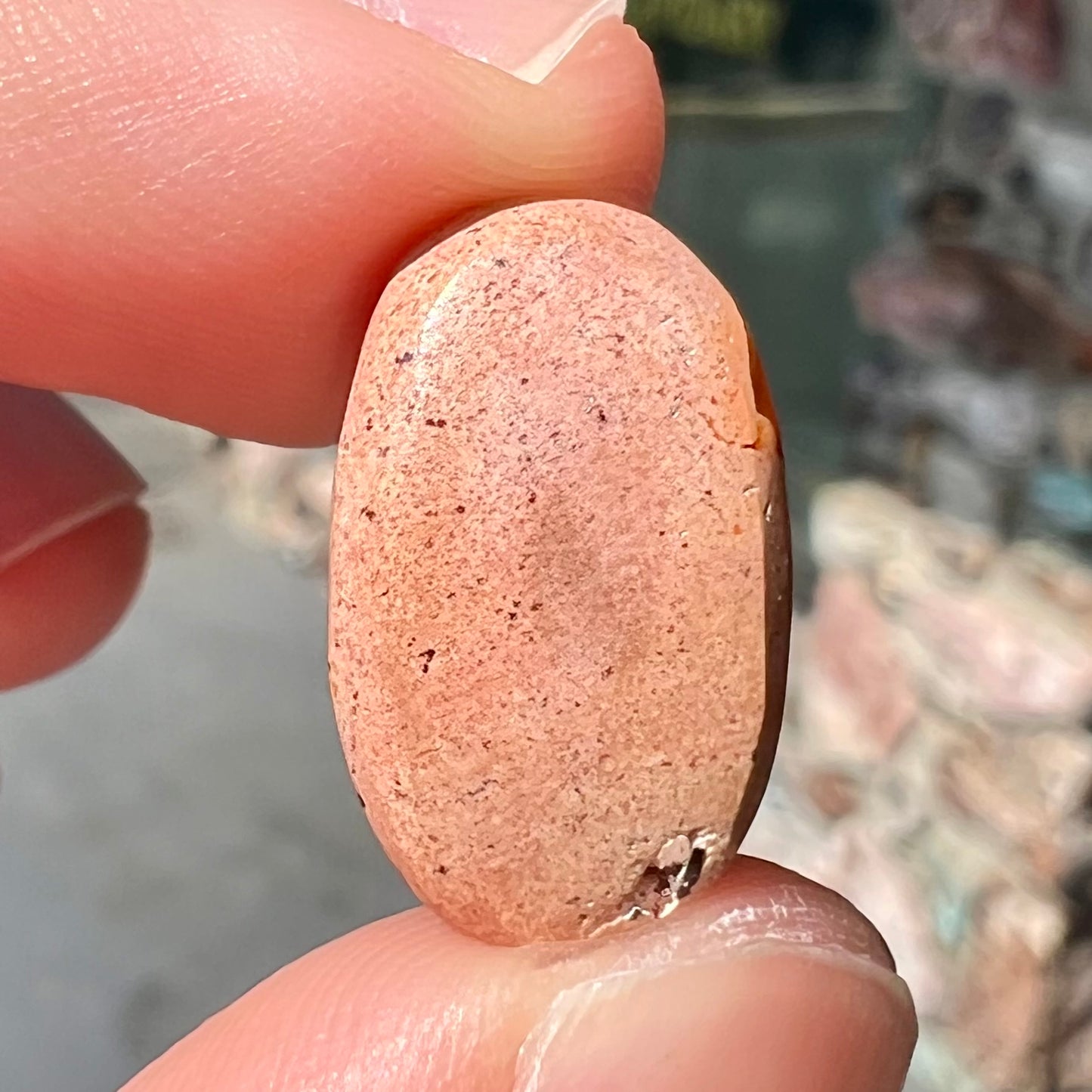 A loose Mexican matrix fire opal stone. The opal is orange with green flashes.