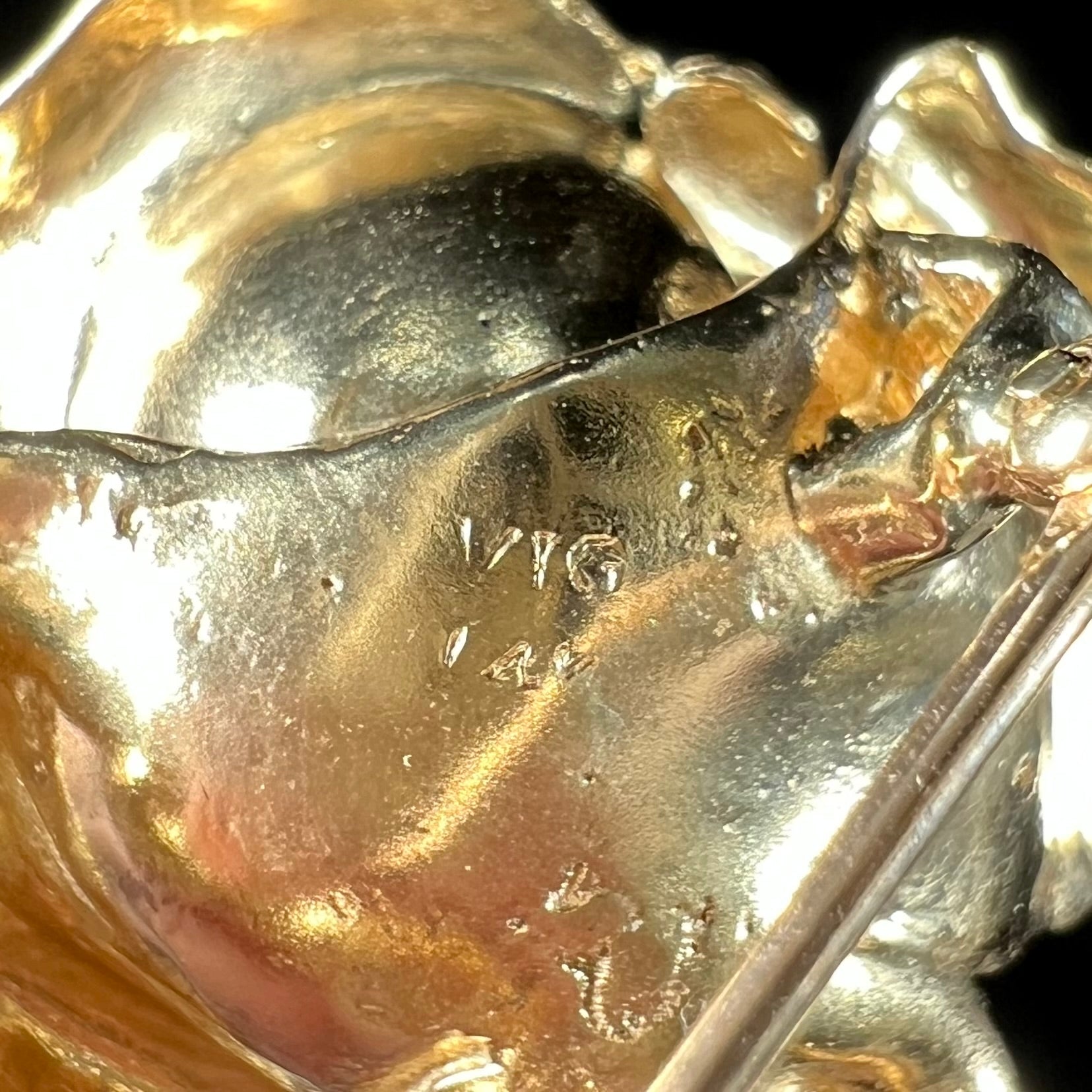 A vintage 14 karat yellow gold rose brooch.