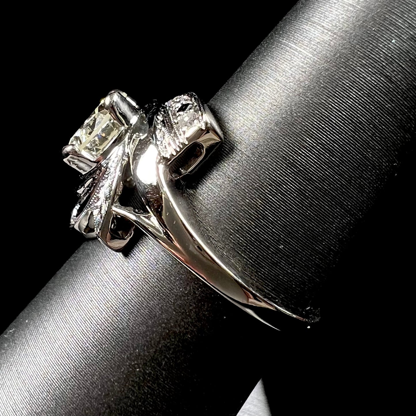 A vintage, Art Nouveau style diamond engagment ring.  The ring is white gold with a yellowish, M colored, 1.24 carat diamond.