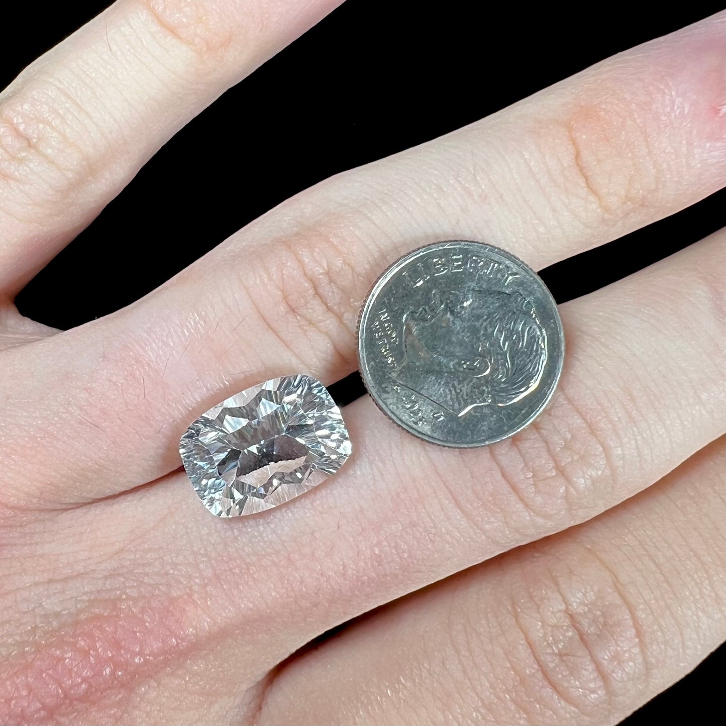 A loose, modified laser cushion cut white topaz gemstone.
