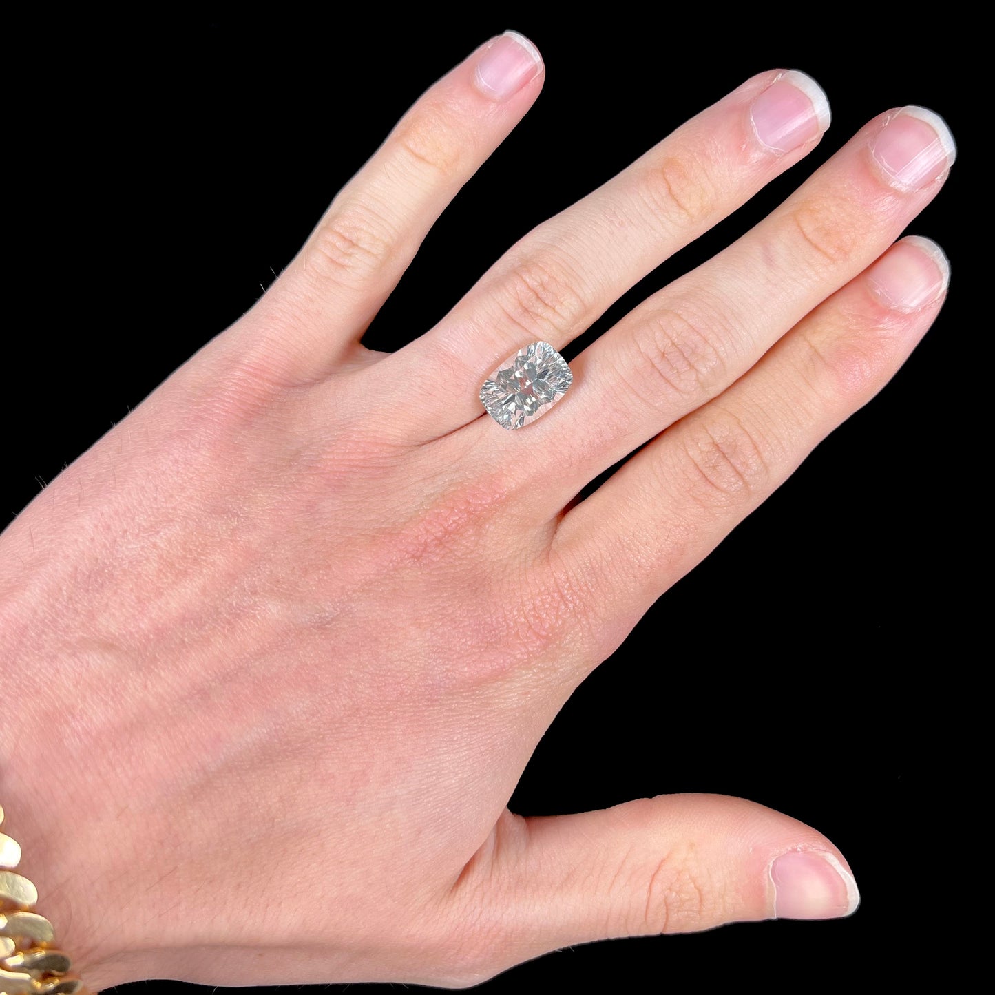 A loose, modified laser cushion cut white topaz gemstone.