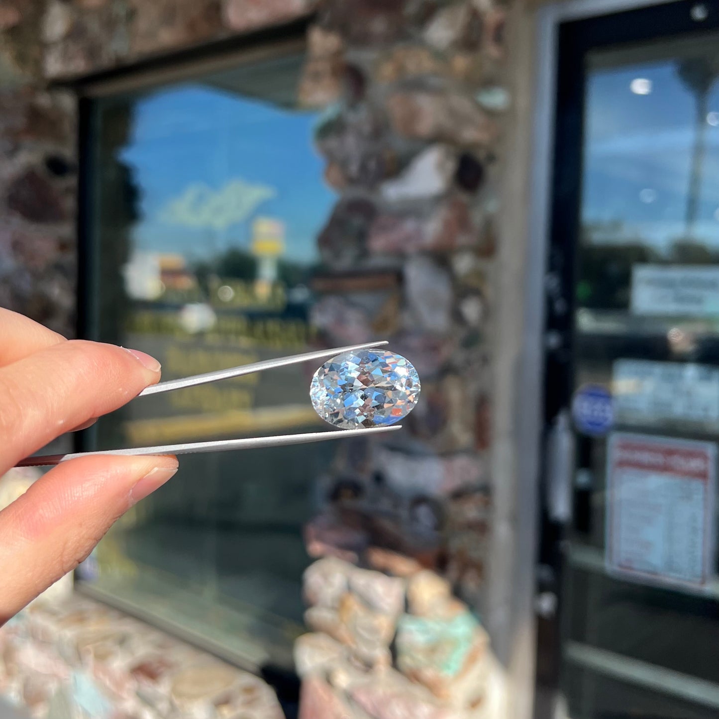 A loose, faceted oval cut white topaz gemstone. The stone is large in size.