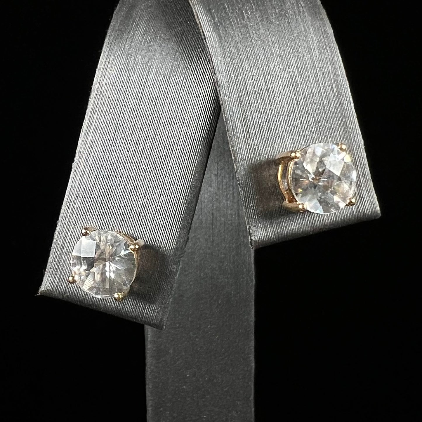 A pair of checkerboard round brilliant cut white zircon stud earrings in yellow gold.