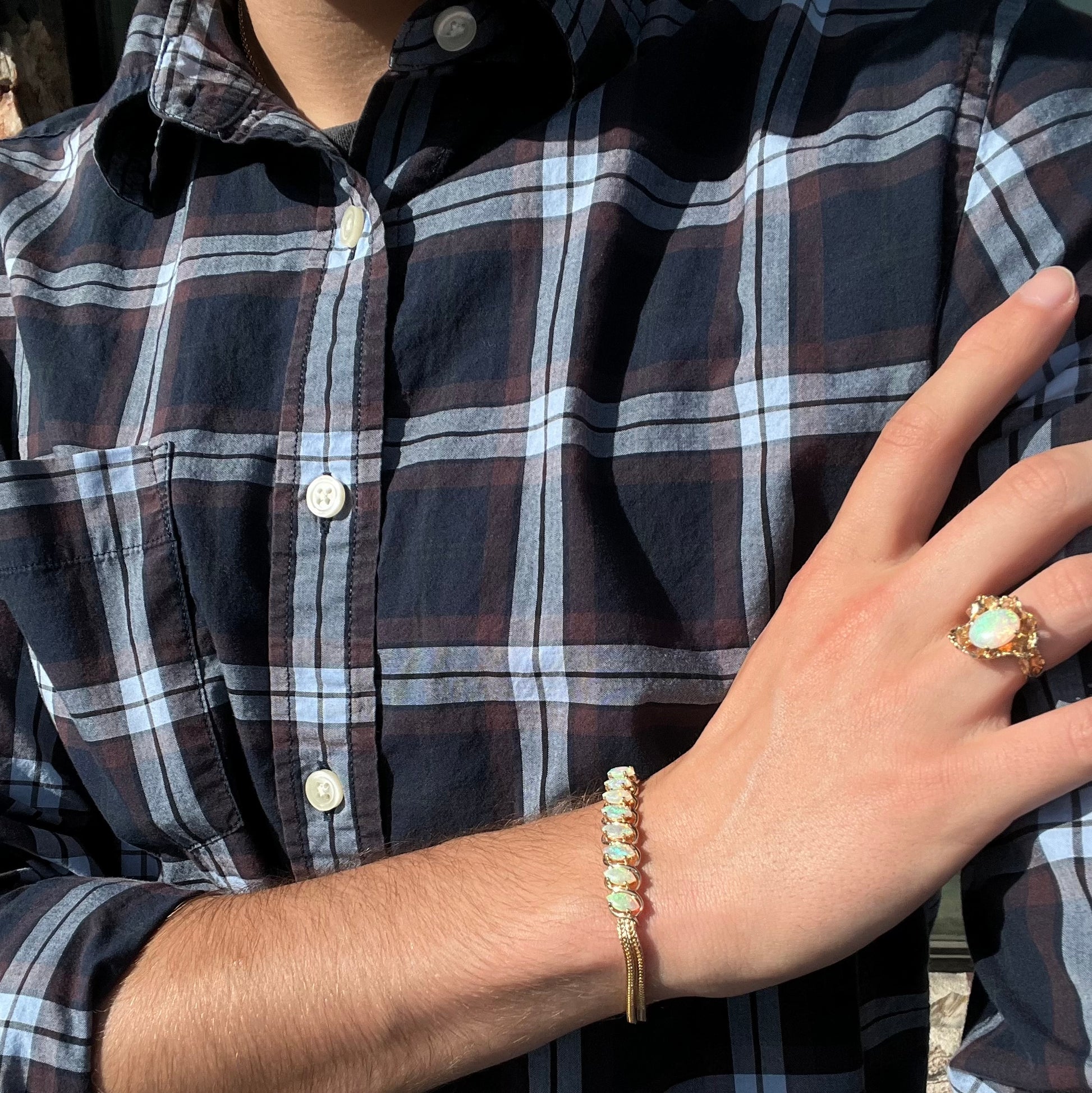 A ladies' yellow gold bracelet prong set with eight natural, marquise cabochon cut opals.