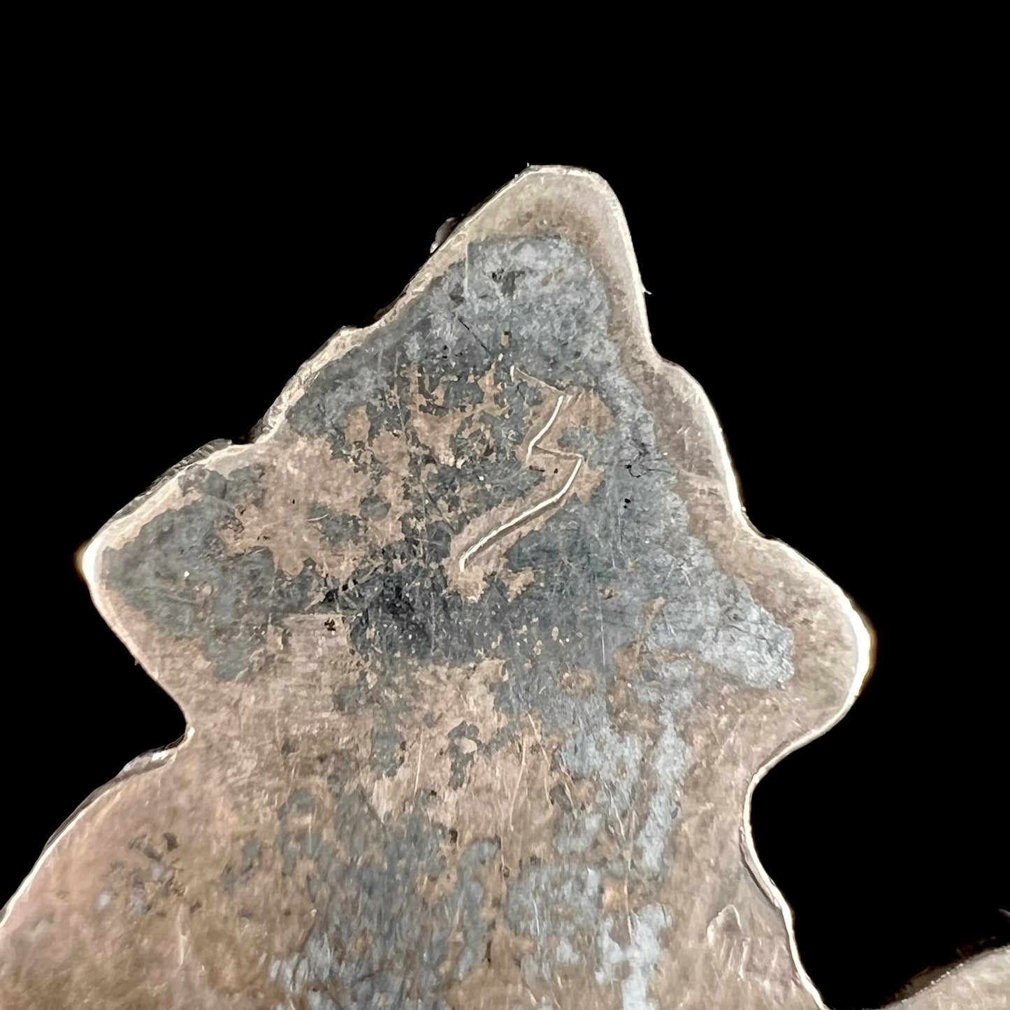 A sterling silver brooch depicting a Zuni Indian knifewing. The back of the piece is etched "3".
