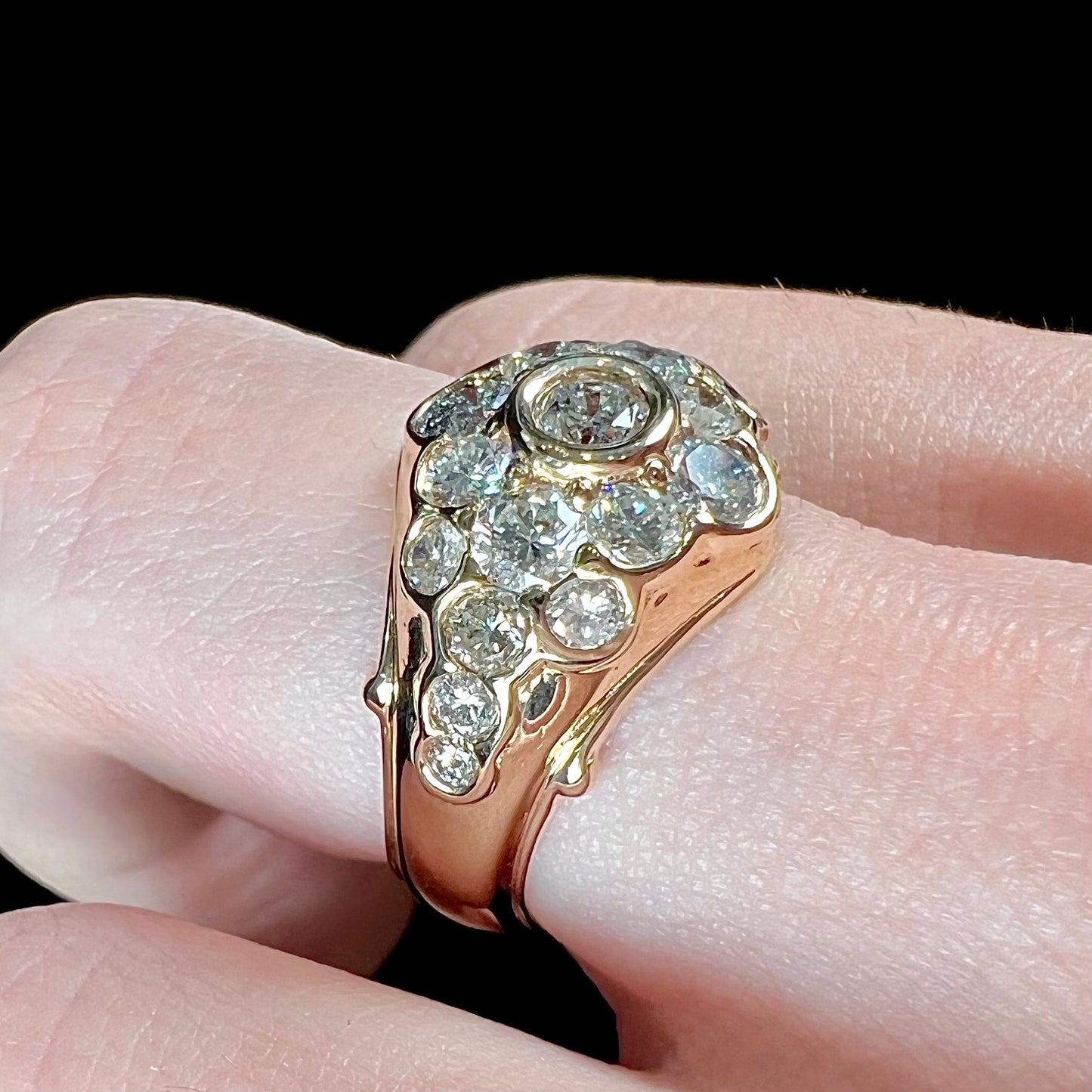 A yellow gold domed diamond ring set with 19 Standard Round Brilliant Cut diamonds.