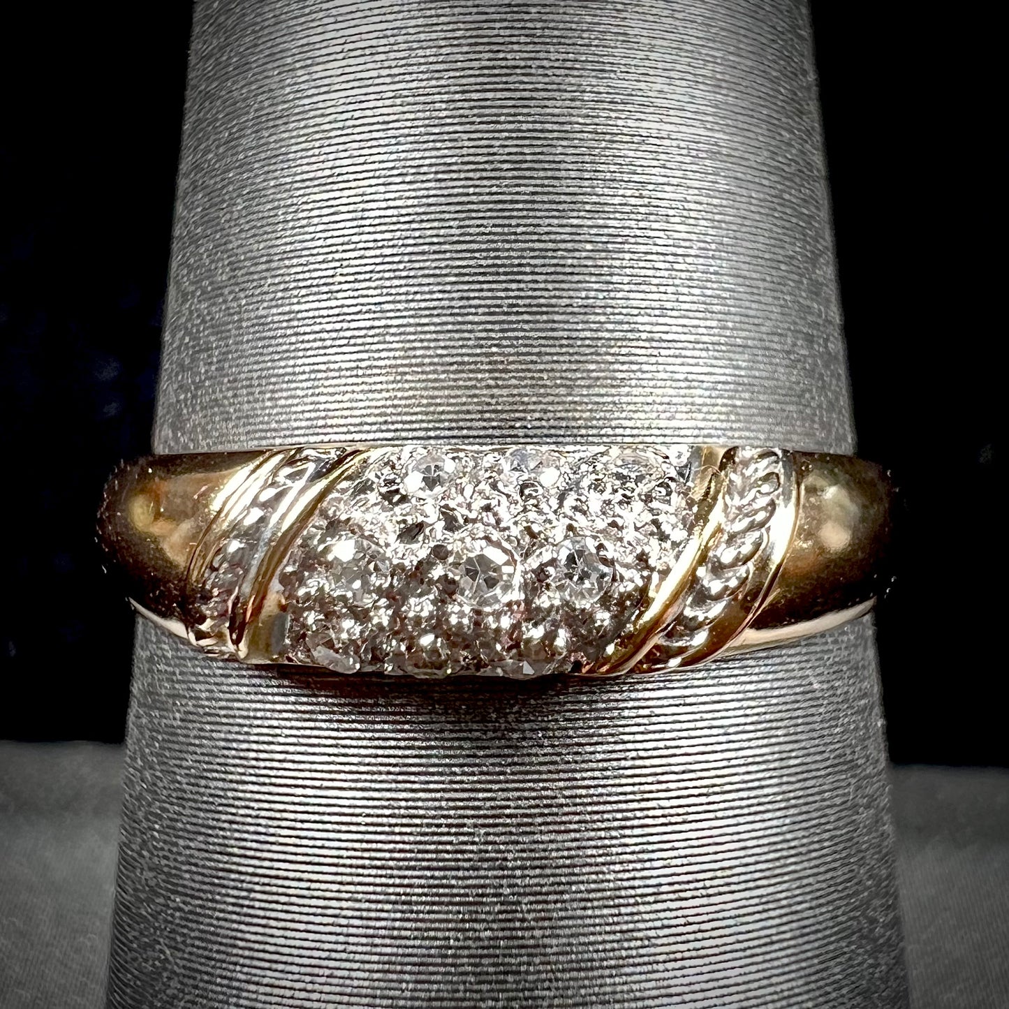 A unisex 18k yellow gold diamond ring pave set with round single cut diamonds.