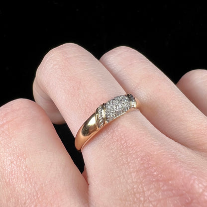 A unisex 18k yellow gold diamond ring pave set with round single cut diamonds.