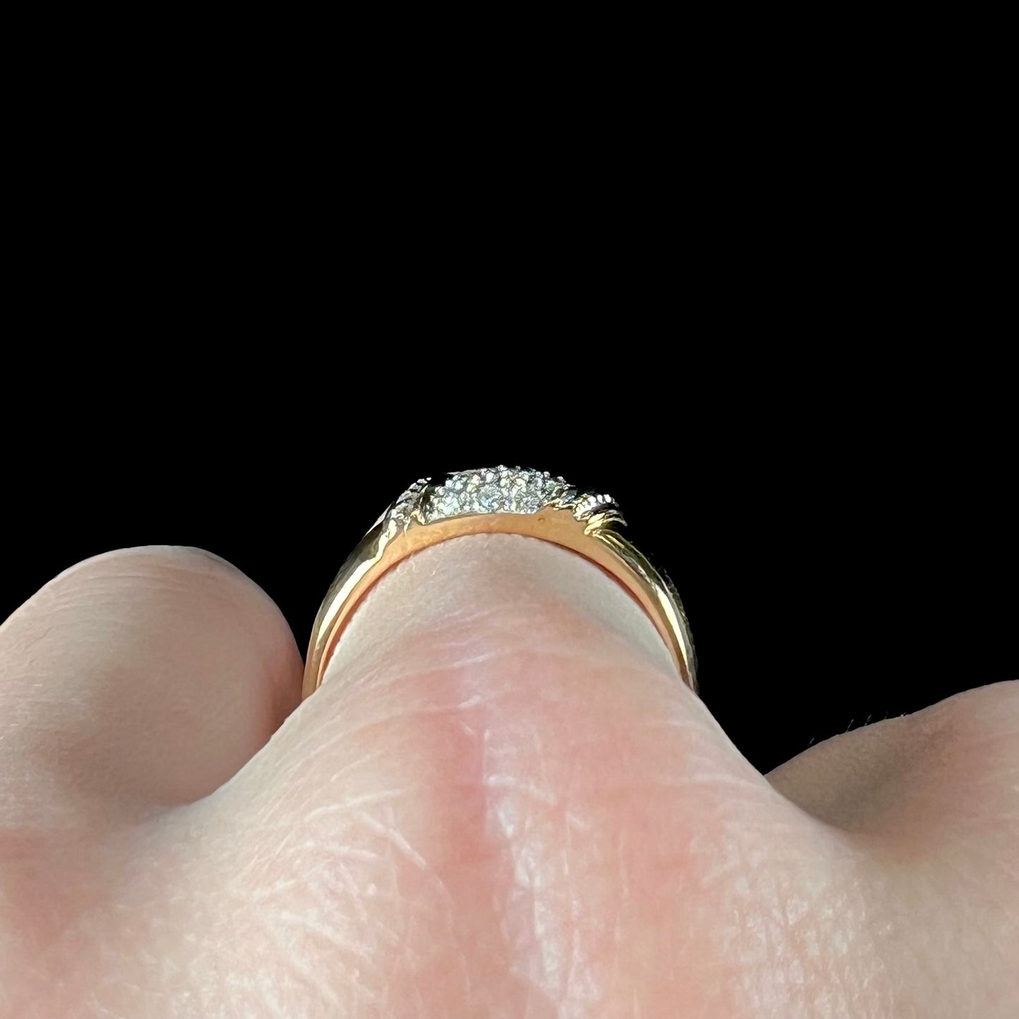 A unisex 18k yellow gold diamond ring pave set with round single cut diamonds.