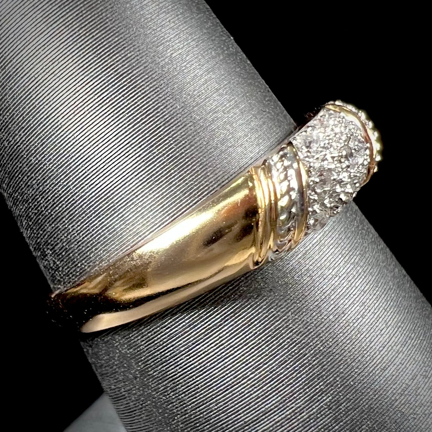 A unisex 18k yellow gold diamond ring pave set with round single cut diamonds.