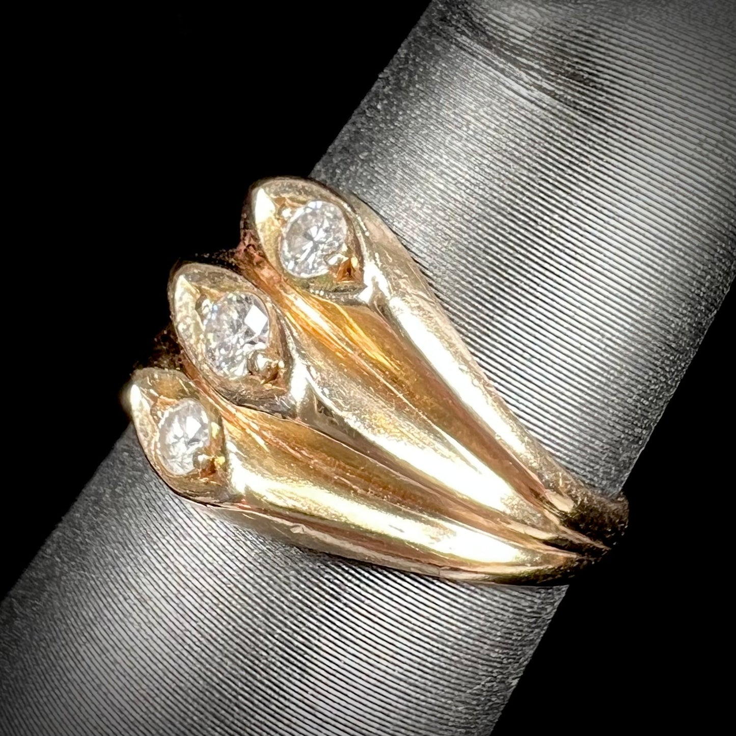 A vintage 1940's style ladies' yellow gold three stone diamond ring.