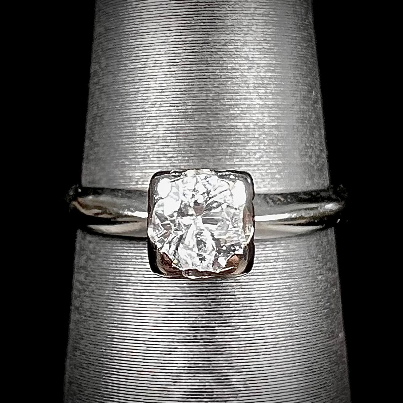 A ladies' vintage 14kt white gold 1940's diamond solitaire ring. The diamond is chipped in two places.