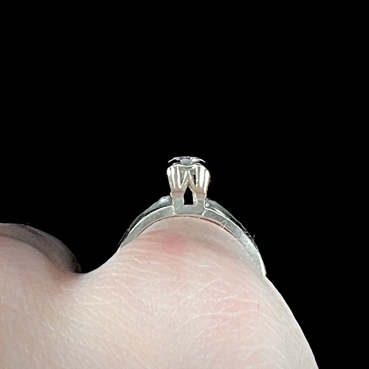 A ladies' vintage 14kt white gold 1940's diamond solitaire ring. The diamond is chipped in two places.