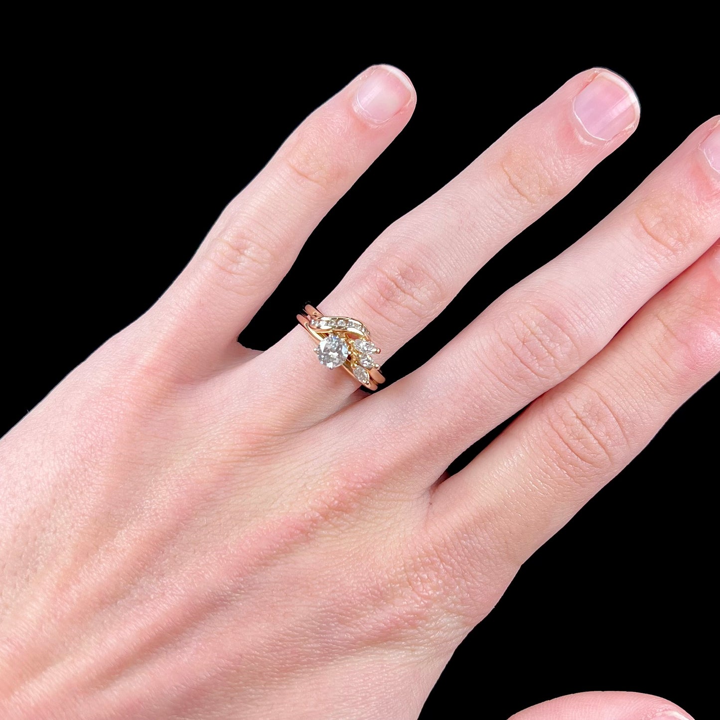 A ladies' diamond wedding set that has been soldered together in yellow gold. There are round and marquise cut diamonds.
