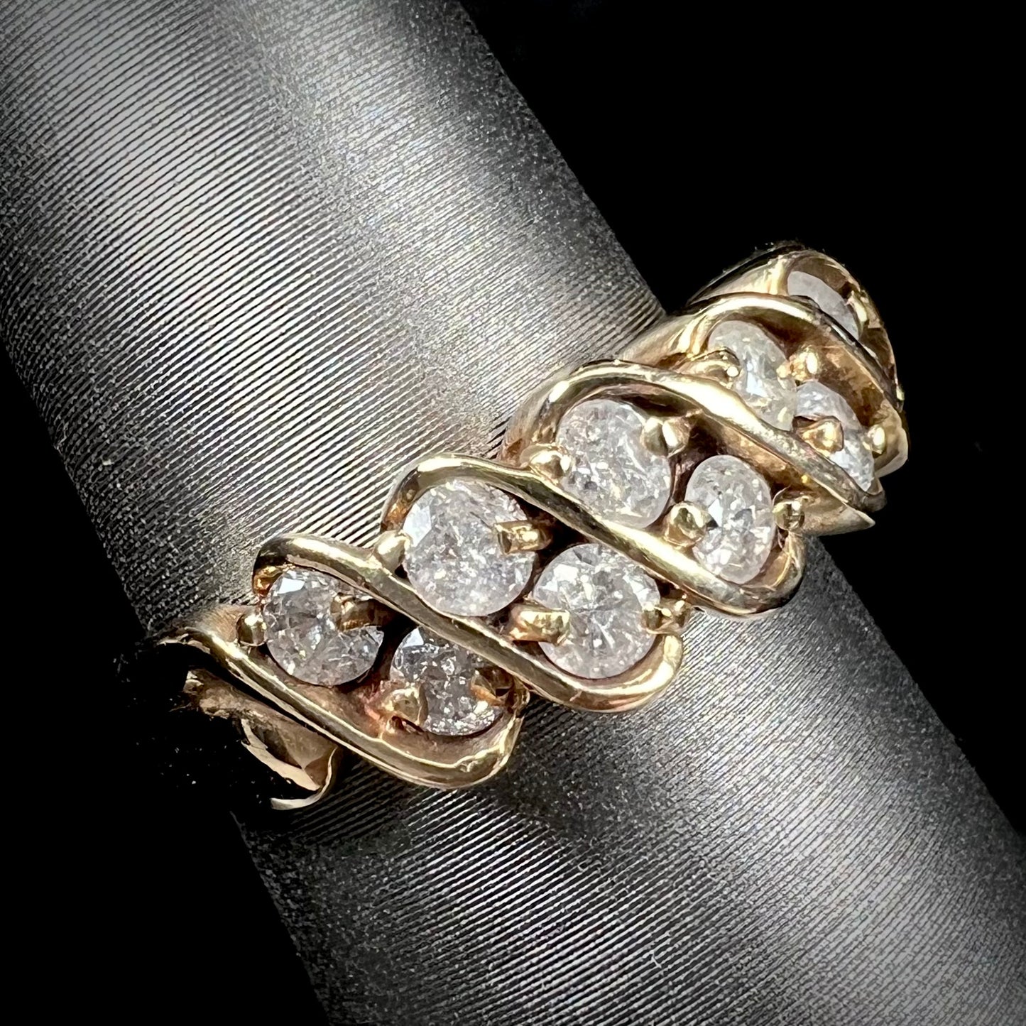 A ladies' estate yellow gold band set with 1 total carat of round brilliant cut diamonds.