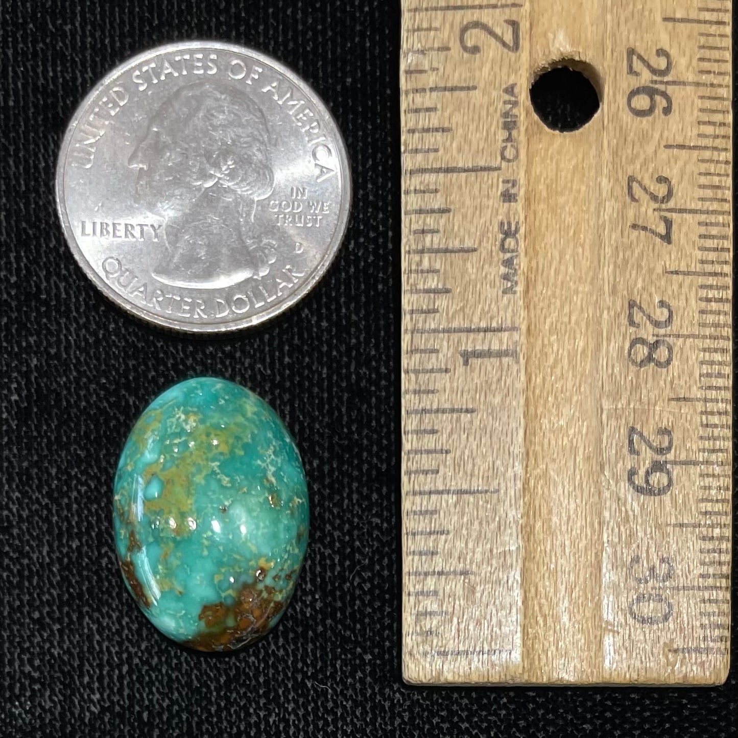 A loose, oval cabochon cut, green turquoise stone from Royston Mining District, Nevada.